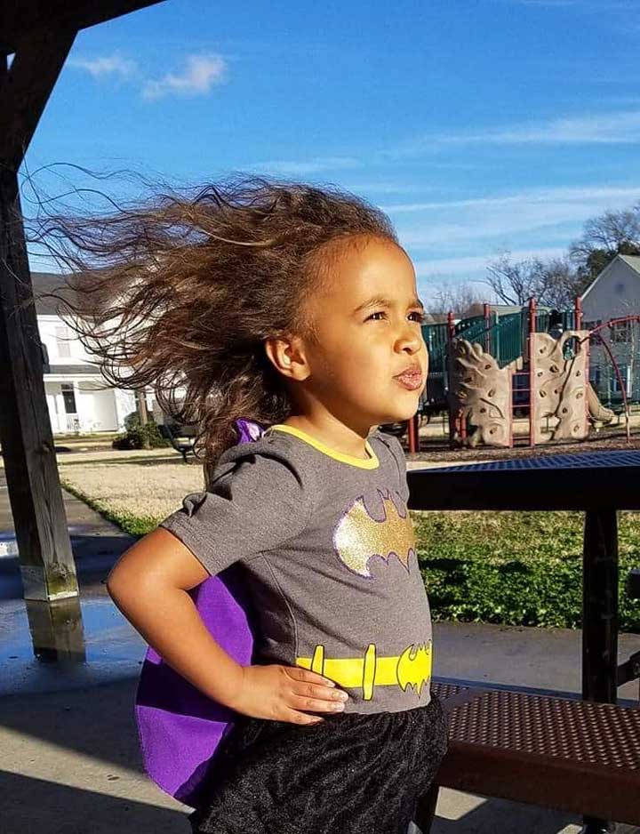 Young girl dressed up as a super hero