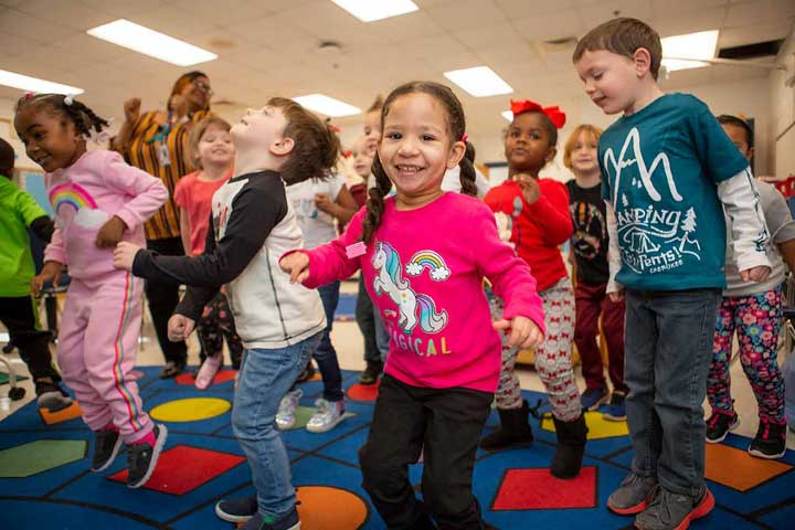 children jumping during morning routine in whole group