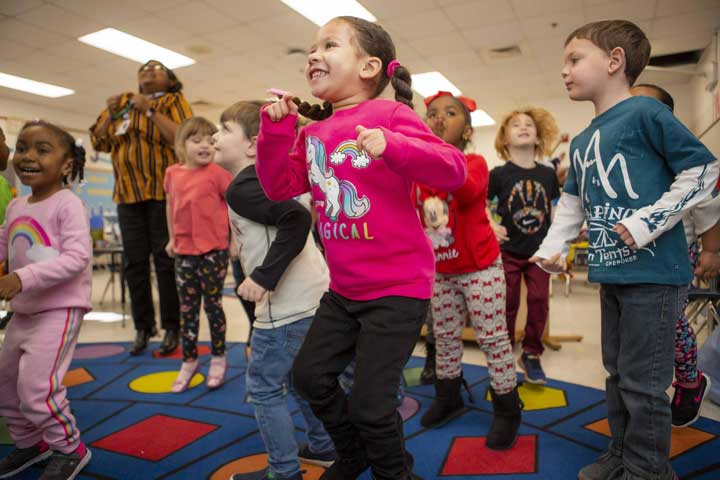 young children playing a self-regulation game, jump and freeze.