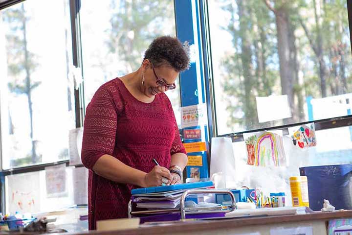 Teacher program leader selecting educational resources