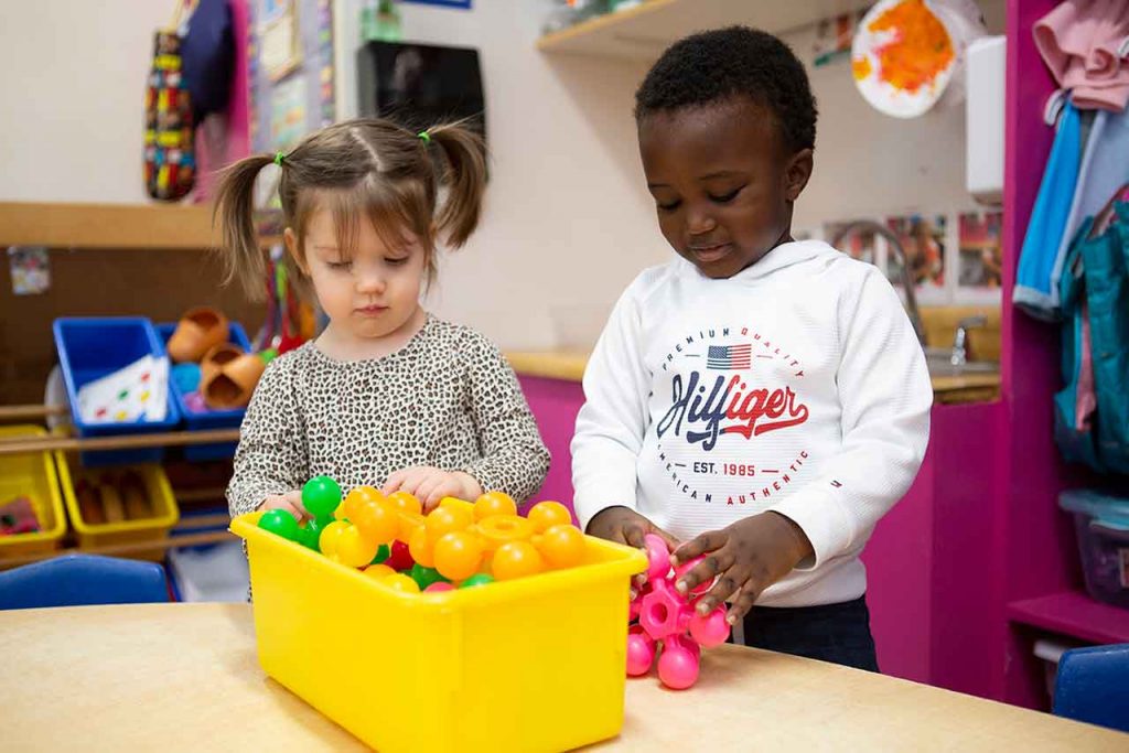 Two children playing with toys.