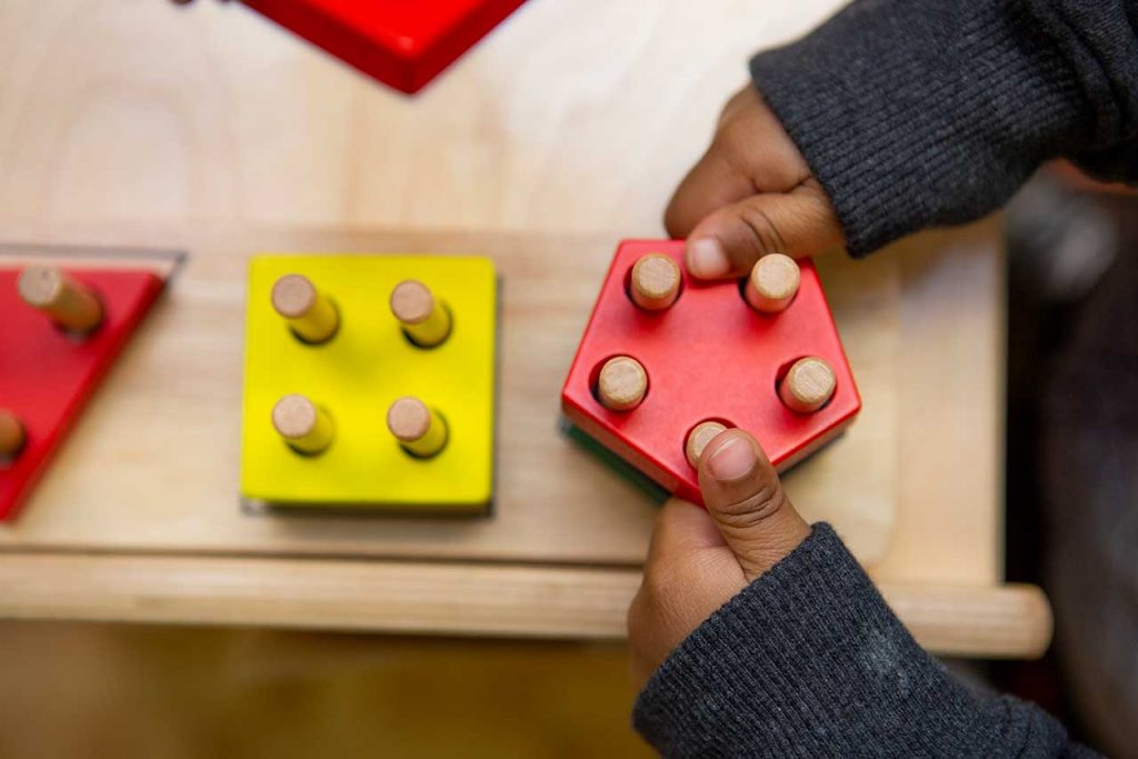 child holding a puzzle piece